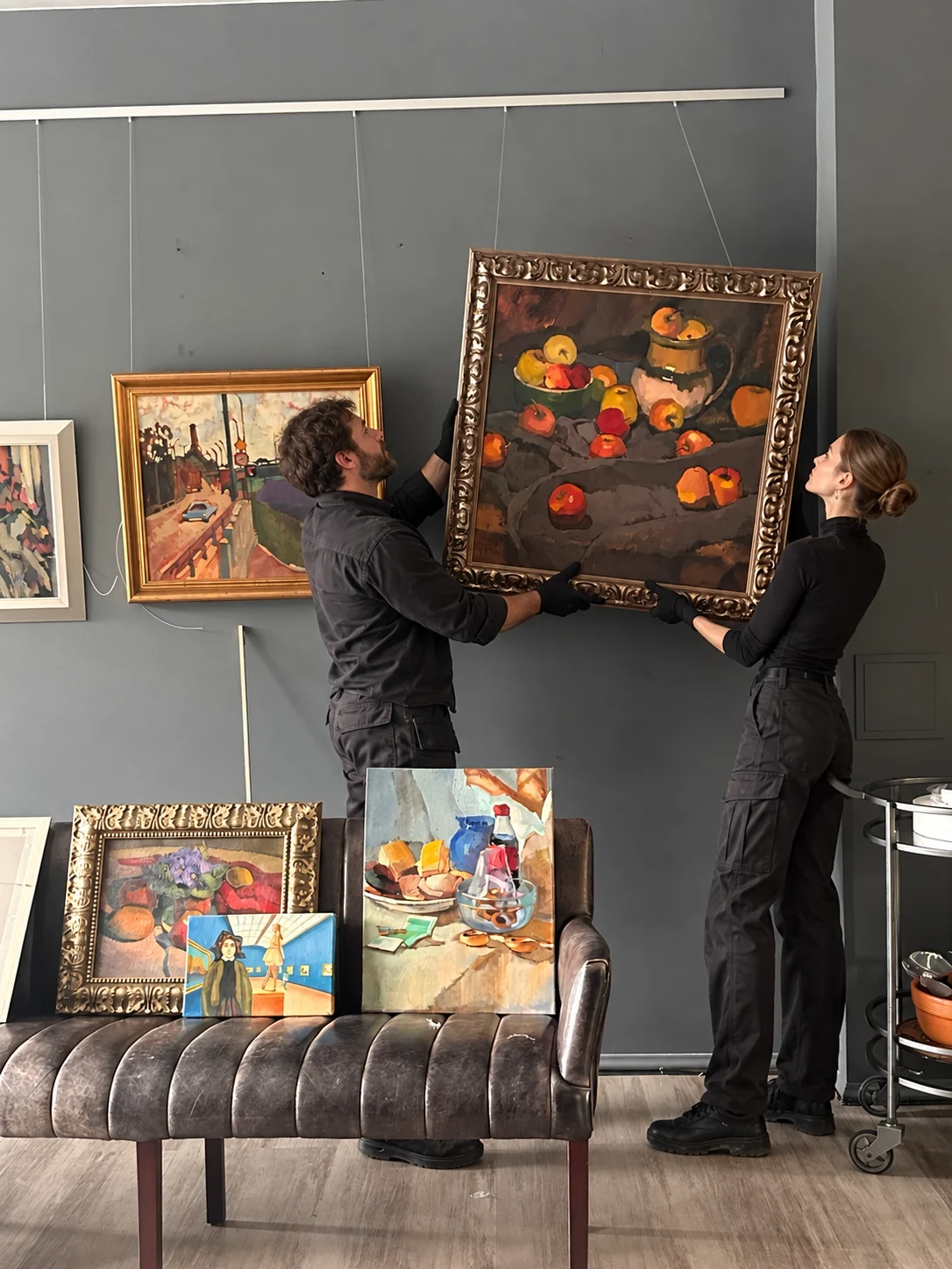 A painting being installed in the gallery